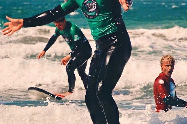 a group of people surfing in the ocean