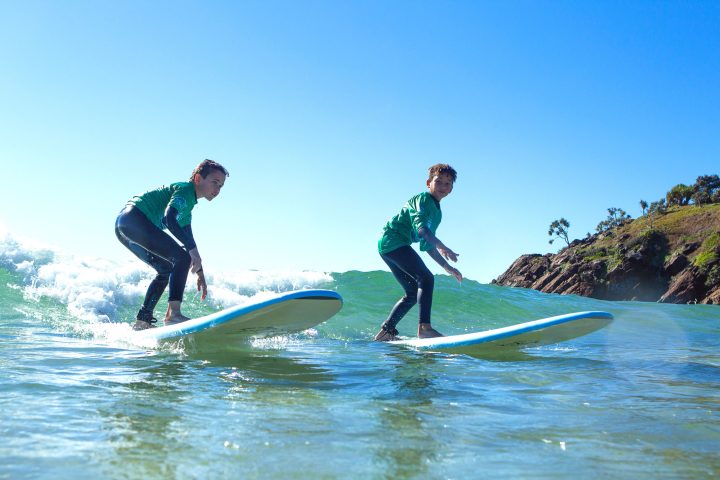 a man riding a wave on a surfboard in the water