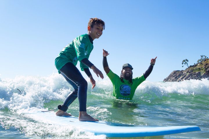 a man riding a wave on a surfboard in the water