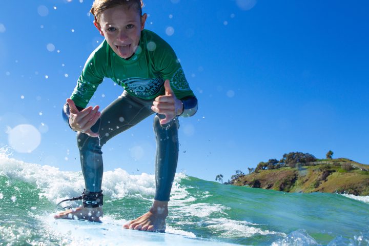 a man riding a surfboard on top of a mountain