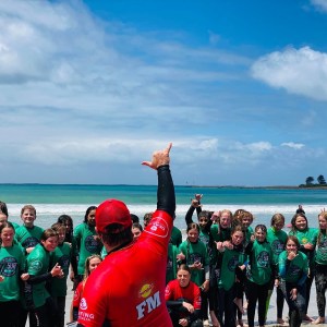 a group of people standing next to a body of water