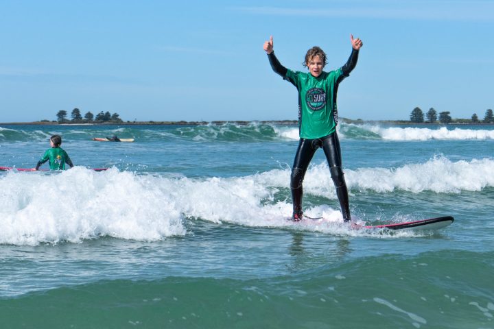 a boy riding a wave