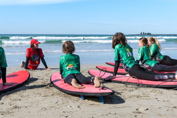 a group of people sitting at a beach