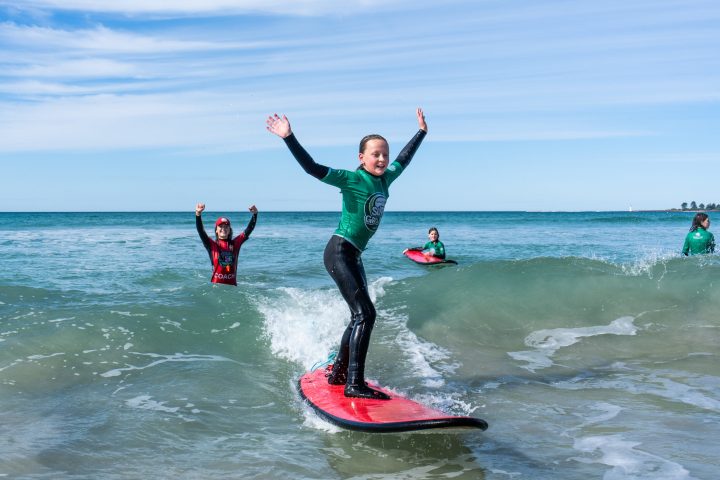 a person riding a surfboard on top of a body of water