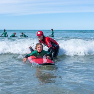 a group of people riding skis on a body of water