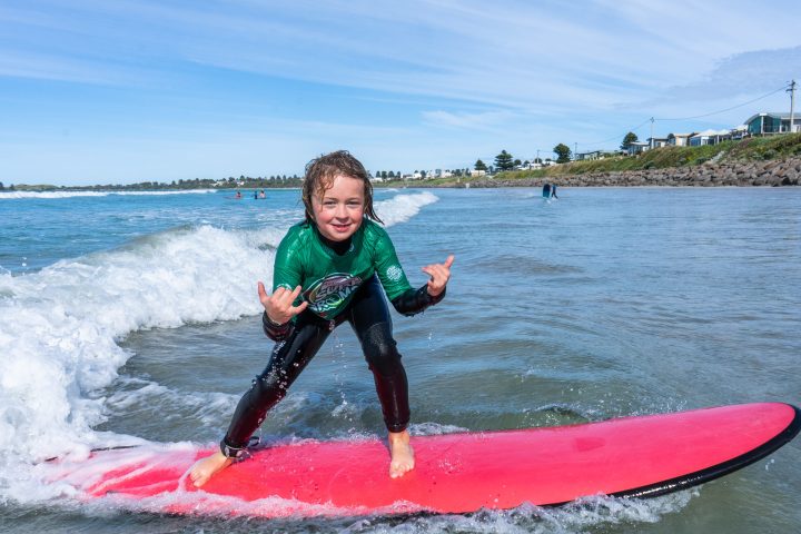 a person riding a surf board on a body of water