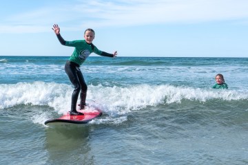 a person riding a wave on a surfboard in the water